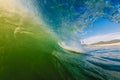 Perfect surfing swell in ocean. Barrel wave with morning warm light