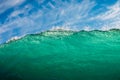 Perfect surfing wave in sea. Breaking turquoise wave with sun light