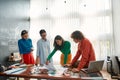 Perfect teamwork. Professional team of young web designers working on a new project together and discussing ideas while Royalty Free Stock Photo