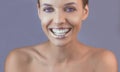 Perfect teeth smile with shiny lips. Beautiful close-up of a tanned face of a young woman with clean fresh skin. Royalty Free Stock Photo