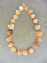 Card background shells on the beach top view heart shape next to the ocean