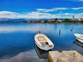 Perfect for a trip with an inflatable kayak. Evening, sunset in the ocean. Kastoria lake at winter. Fishing boat waiting among the Royalty Free Stock Photo