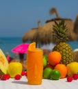 Perfect tropical cocktail juice with a paper parasol and fresh fruits on a beach Royalty Free Stock Photo