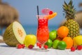 Perfect tropical cocktail with a paper parasol and fresh fruits on a beach Royalty Free Stock Photo