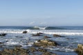 Perfect wave breaking behind the rocks Royalty Free Stock Photo