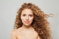 Perfect wavy hair woman. Young fashion model with long curly hairstyle and natural fresh clear skin posing on white background Royalty Free Stock Photo