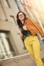 Perfect weather for walking. Full length of a young happy beautiful woman or business lady looking aside and smiling Royalty Free Stock Photo