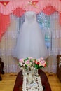 The perfect wedding dress with a full skirt on a hanger in the room Royalty Free Stock Photo