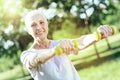 Enthusiastic pensioner being satisfied with little hand weights