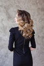 Perfect woman back and head with curly hairdo on gray background Royalty Free Stock Photo