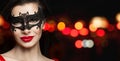 Perfect woman face in black carnival mask and red lips makeup on black background with abstract night glitter bokeh Royalty Free Stock Photo