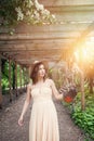 Perfect woman in fedora hat in spring garden. Girl training hawk bird outdoors Royalty Free Stock Photo