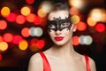 Perfect young woman in black carnival mask on abstract night glitter bokeh background Royalty Free Stock Photo