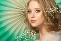 Perfect young woman with flowers on green background Royalty Free Stock Photo