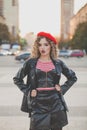 Perfect young woman wearing black leather jacket and red beret posing on the city street Royalty Free Stock Photo