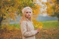 Perfect young woman with yellow leaves on fall nature background Royalty Free Stock Photo