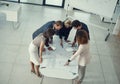 Perfection is in the details. a team of corporate architects collaborating on a plan in a modern office.