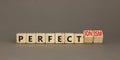 Perfectionism symbol. Concept words Perfect or Perfectionism beautiful wooden blocks. Beautiful grey table grey background.