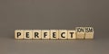 Perfectionism symbol. Concept words Perfect or Perfectionism beautiful wooden blocks. Beautiful grey table grey background.