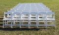 Empty white wedding chairs on lawn Royalty Free Stock Photo