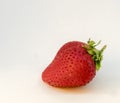 A perfectly cleaned strawberry with leaves isolated on the white background