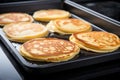 perfectly flipped pancakes on a non-stick griddle Royalty Free Stock Photo