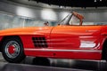 Perfectly polished. Vintage red polished car standing indoor. Photo from the side