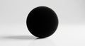 A perfectly round, black sphere is centered on a smooth, white surface. The sphere casts a subtle Royalty Free Stock Photo