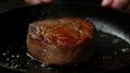 Perfectly seared beef steak cooking in a cast iron skillet. Royalty Free Stock Photo