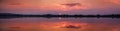 Perfectly specular reflection on the Molentargius pond in Cagliari at sunset. Panoramic view. Royalty Free Stock Photo