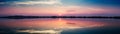 Perfectly specular reflection on the Molentargius pond in Cagliari at sunset. Panoramic view. Royalty Free Stock Photo