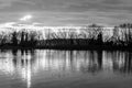 A perfectly symmetric view of a lake, with trees reflections on water