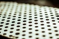 Perforated aluminium sheet of metal texture. Vinatge urface with depth of field, abstract industrial mesh old background Royalty Free Stock Photo