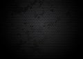 Perforated black grungy metallic plate background