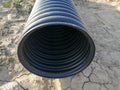 Black corrugated pipe for water canalization Royalty Free Stock Photo