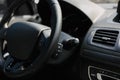 Perforated leather steering wheel in the interior of a luxury modern car.