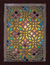 Stucco window decorated with colorful stain glass with geometrical circular patterns, an Ottoman era tradition