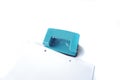 Perforator, blue hole puncher is going to punch the paper isolated on a white Royalty Free Stock Photo