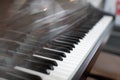 Keys of a concert piano or grand piano in daylight, no one nearby, glare from the sun