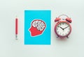 Performance concepts with pencil and brain sign drawing and alarm clock on white background