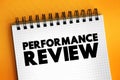 Performance Review - formal assessment in which a manager evaluates an employee`s work performance, text concept on notepad