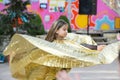 Performance of a young dancer. Little girl dance poses. Speech by a young girl in a black dress. Swinging a yellow fan