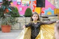Performance of a young dancer. Little girl dance poses. Speech by a young girl in a black dress. Swinging a yellow fan