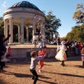 A performer blows bubbles for children in City Park, New Orleans