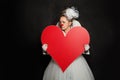 Performer woman clown holding white empty heart banner Royalty Free Stock Photo