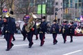 Performers are walking Down the street with Brass Instruments during The Annual Santa Claus Parade Royalty Free Stock Photo