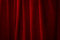 Performing arts stage and presenting a show concept with red velvet curtains with ambient light that casts strong dramatic shadow Royalty Free Stock Photo