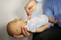 Performing cpr on a simulation mannequin baby dummy during medical training Pediatric Basic Life Support Royalty Free Stock Photo