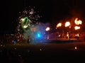 Performing fireshow at night surrounded by a crowd of people