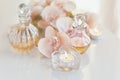 perfume and aromatic oils bottles surrounded by flowers and candles Royalty Free Stock Photo